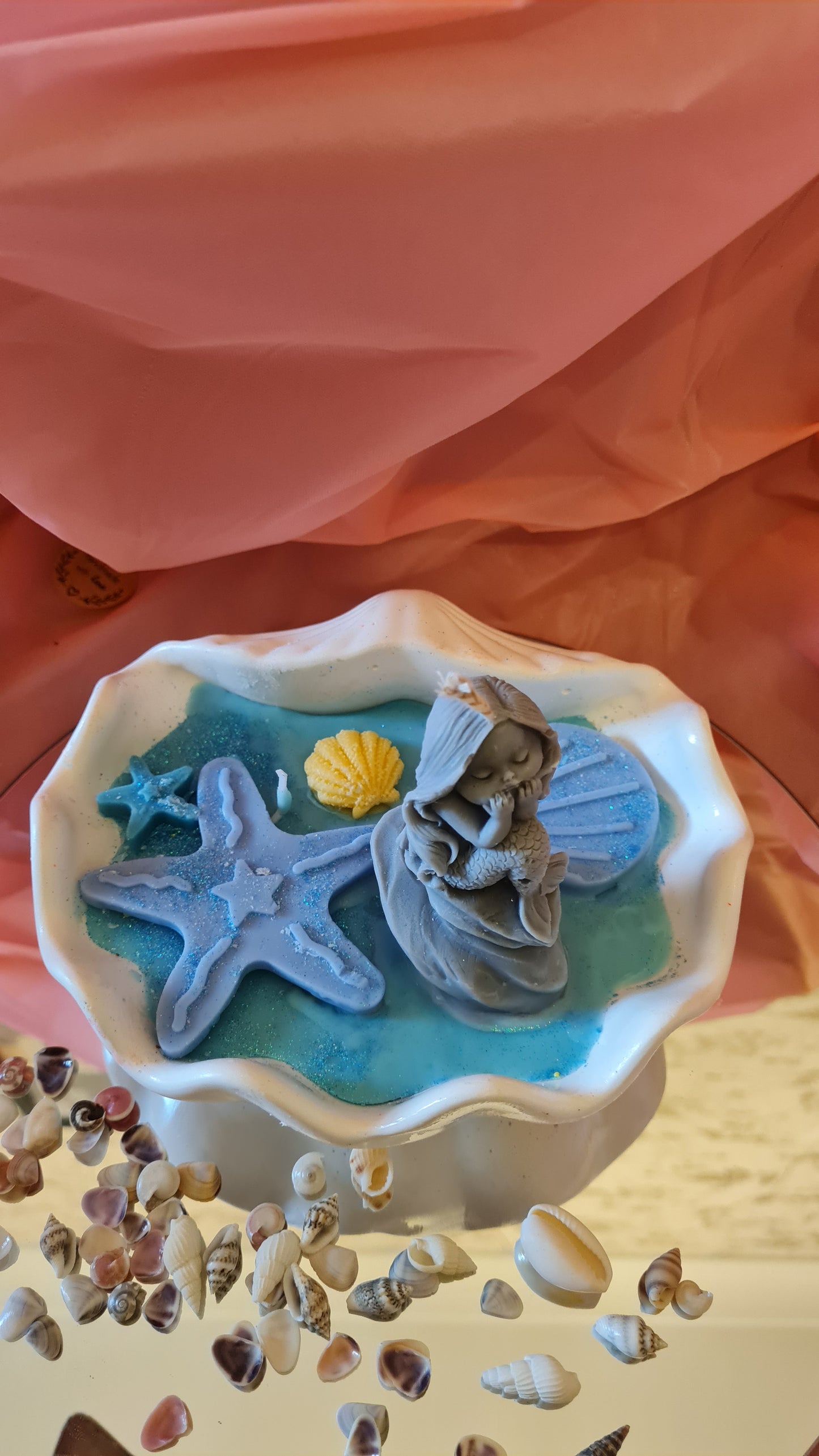 Clam filled with soy wax decorated with Starfish and a Mermaid on a rock.