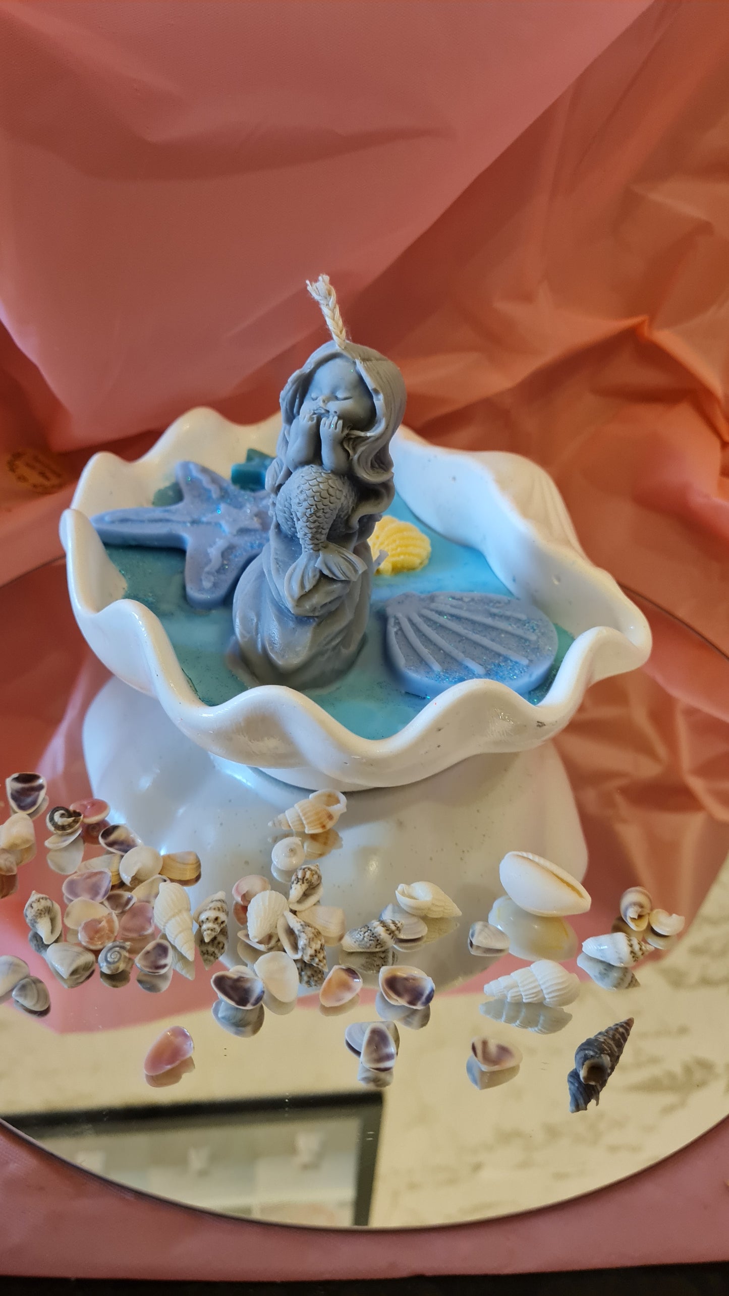 Clam filled with soy wax decorated with Starfish and a Mermaid on a rock.